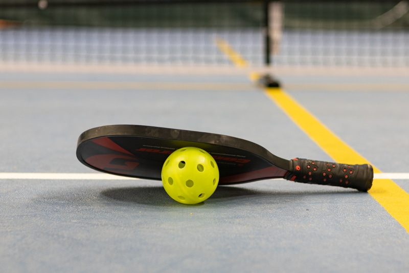 a pickleball paddle and ball